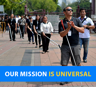 Our Mission Is Universal. Visioneer Juan Ruiz leads a group of blind student coaches in Bangkok.