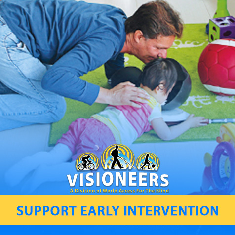 Visioneers. Support Early Intervention. Image: Lead Visioneer Daniel Kish makes FlashSonar clicks into a bowl as he instructs Little Ran at her level on a carpet.