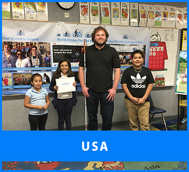 USA. Senior Visioneer Brian Bushway stands for a photo with students at a Los Angeles school after a FlashSonar Workshop at their Science Fair.